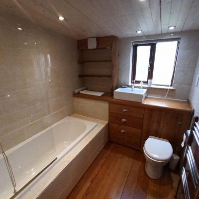 The bathroom at Birch Cottage with underfloor heating bath and shower