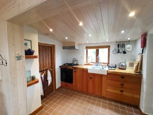 Kitchen area and pantry inside Birch Cottage, powered by renewable energy